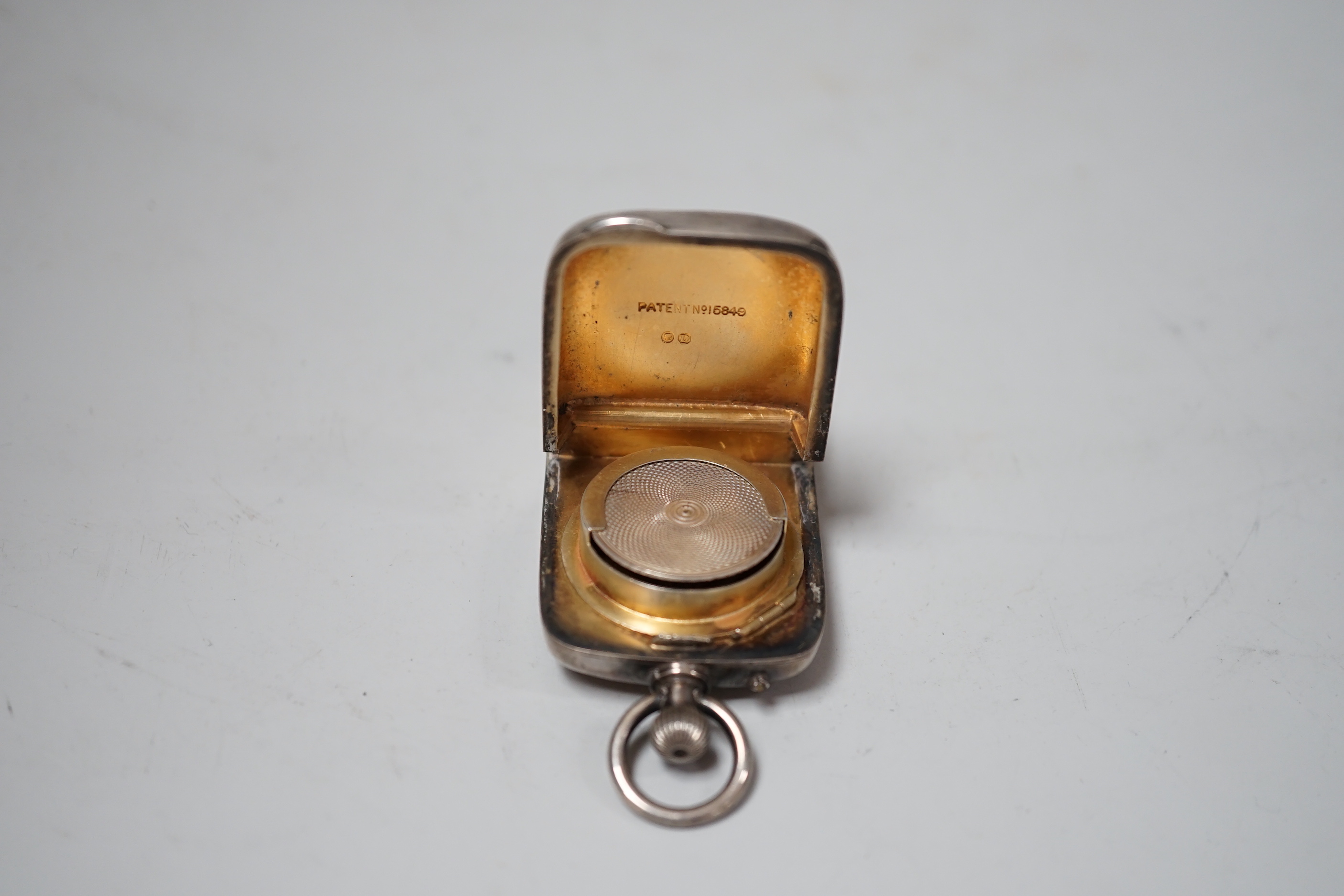 A late Victorian silver combination vesta and sovereign case with inset timepiece, William Neale & Son, Chester, 1887, 75mm.